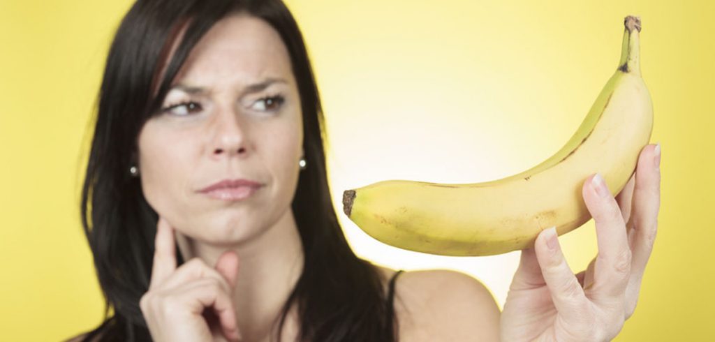 woman looking at a banana